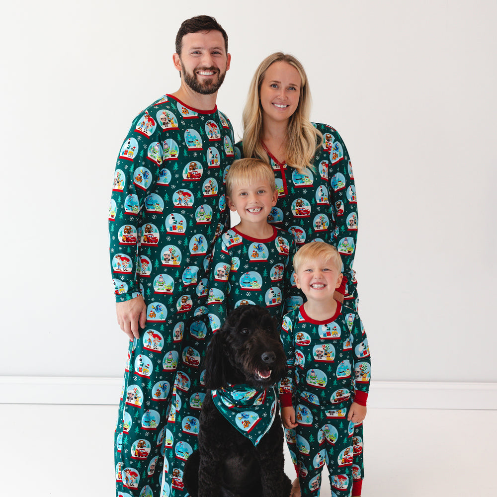 Family of four and a dog wearing matching A Very Pixar Christmas pajamas