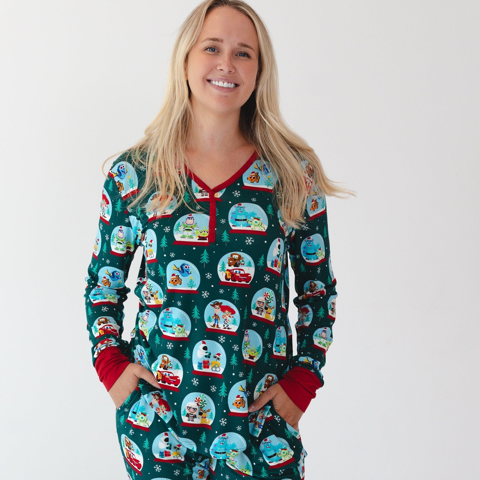 Close up image of smiling female model wearing the Disney A Very Pixar Christmas Women's Pajama Top