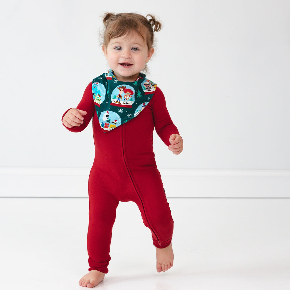 Image of a child wearing a Holiday Red Zippy and A Very Pixar Christmas Bandana Bib