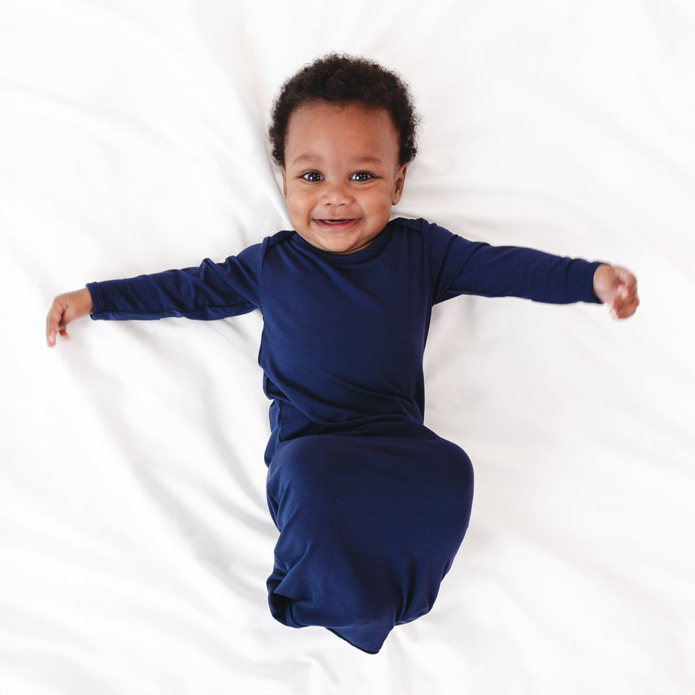 Top view image of baby smiling while in the Classic Navy Infant Gown