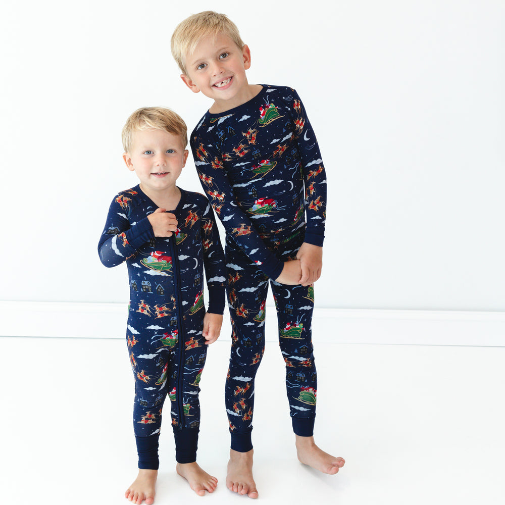 Image of two children wearing matching Santa's Sleigh pajamas