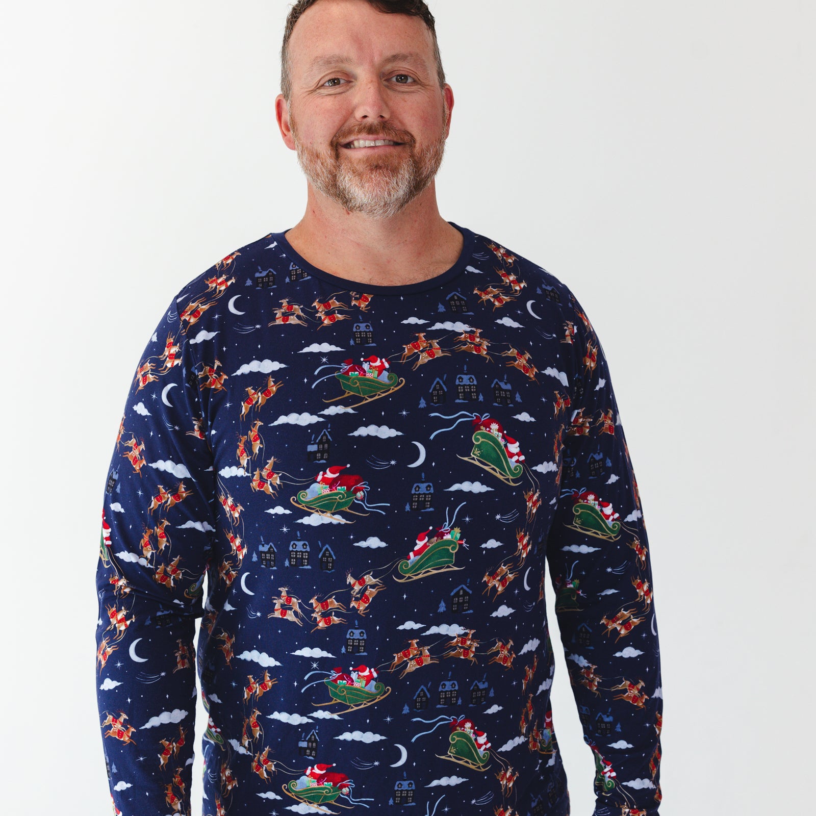 Close up image of a man wearing a Santa's Sleigh Men's Pajama Top