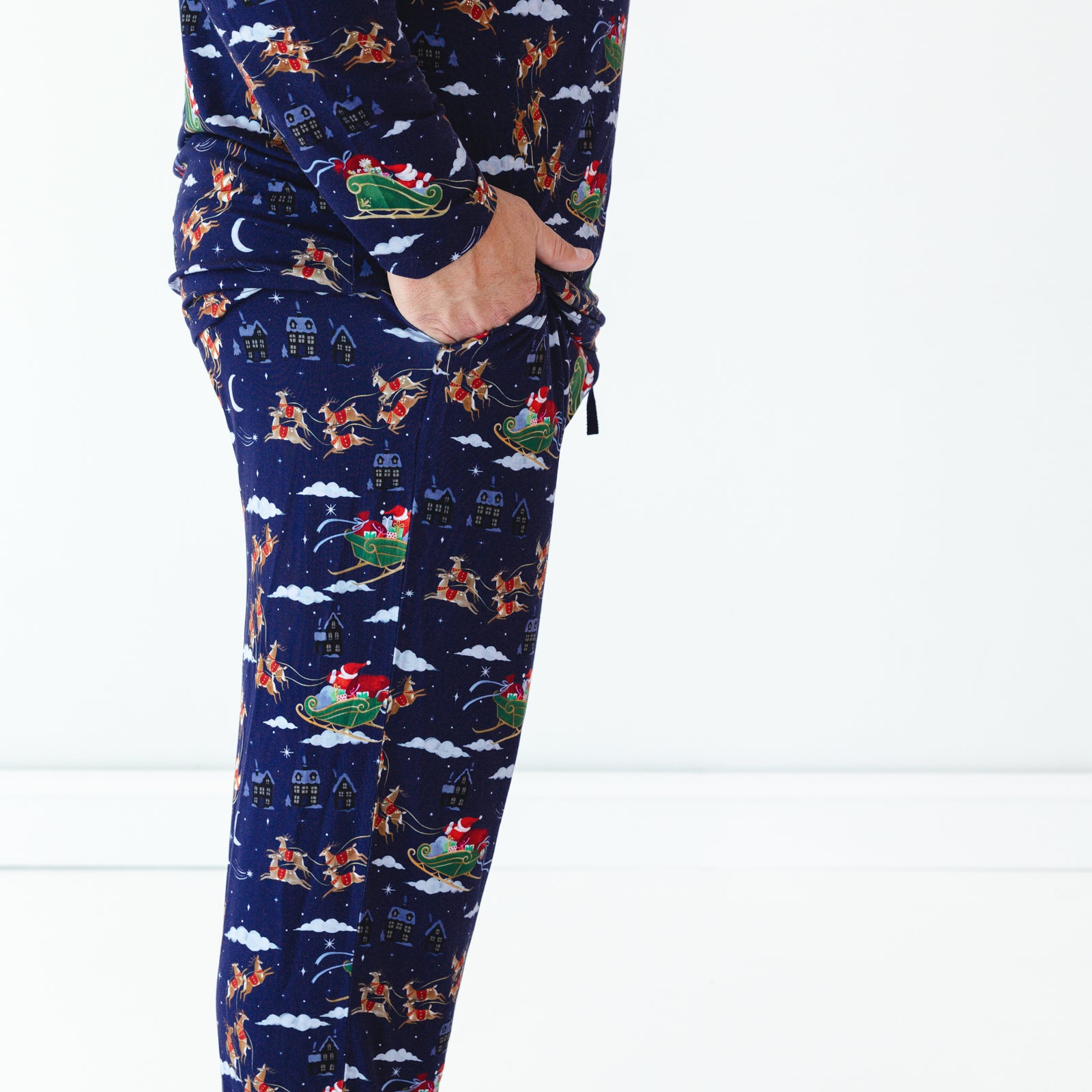 Close up side view image of a man wearing Santa's Sleigh Men's Pajama Pants