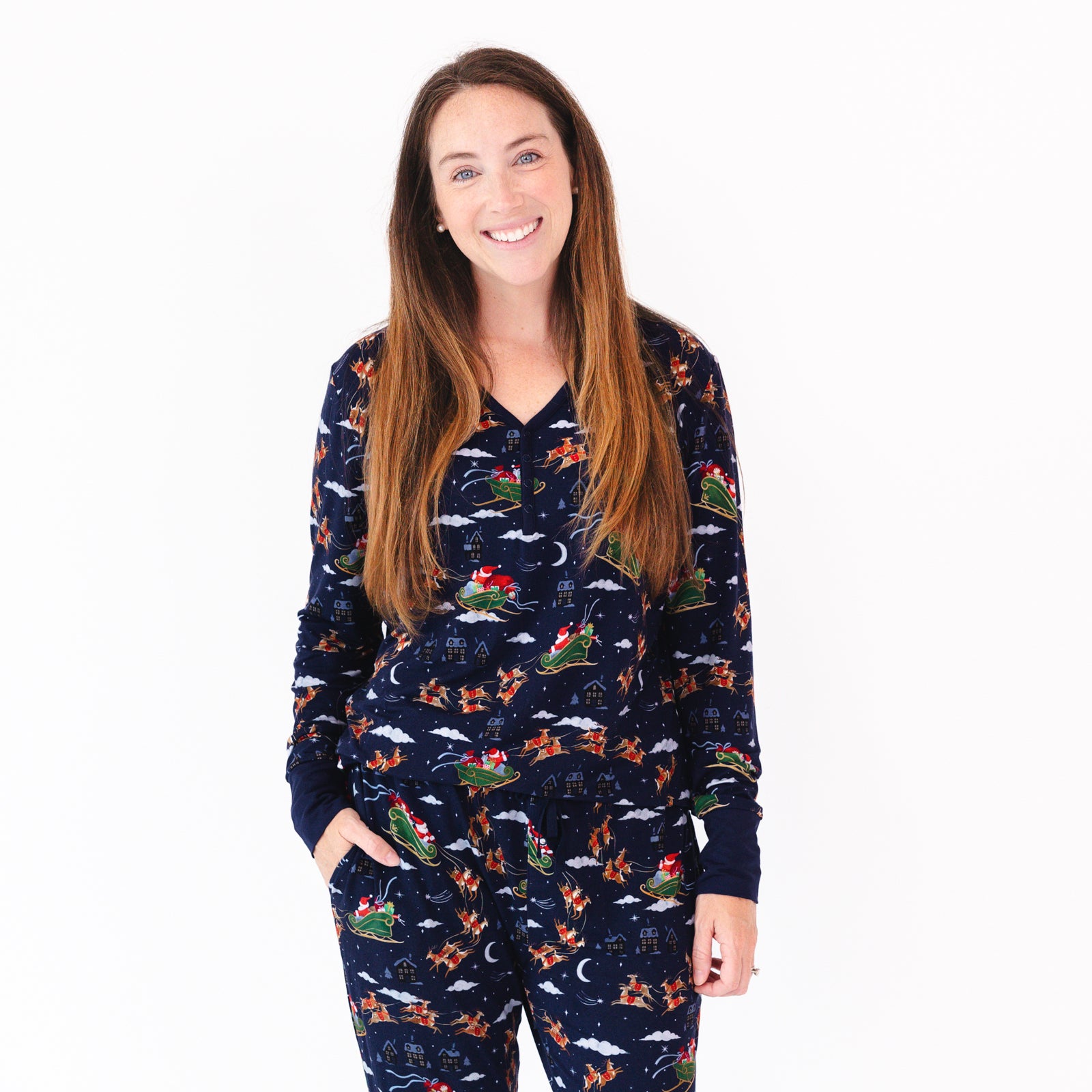 Close up image of a woman wearing a Santa's Sleigh Women's Pajama Top and matching pajama pants