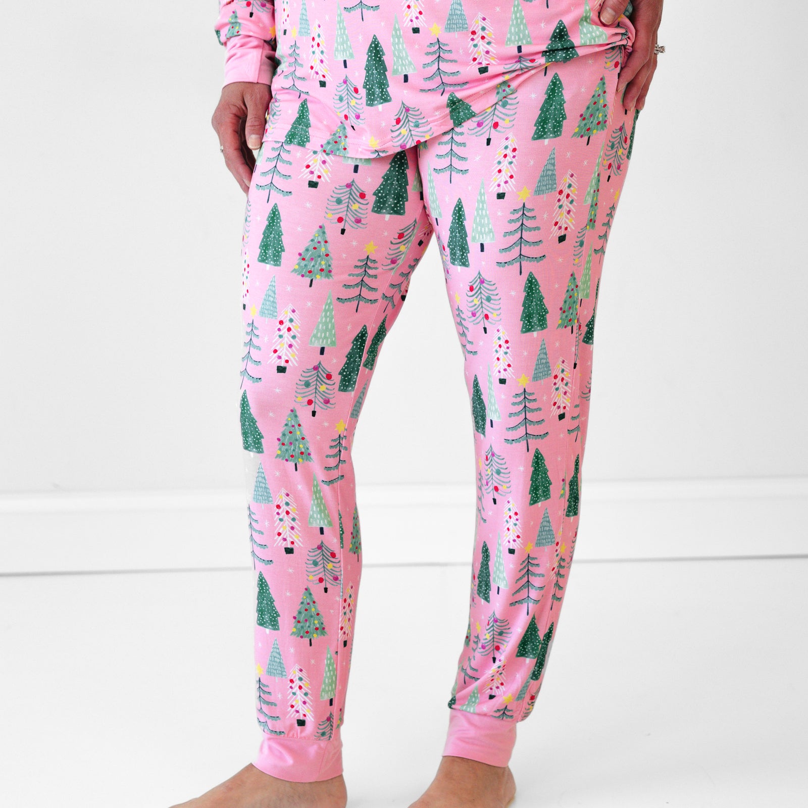 Close up image of a woman wearing Pink Twinkling Trees Women's Pajama Pants