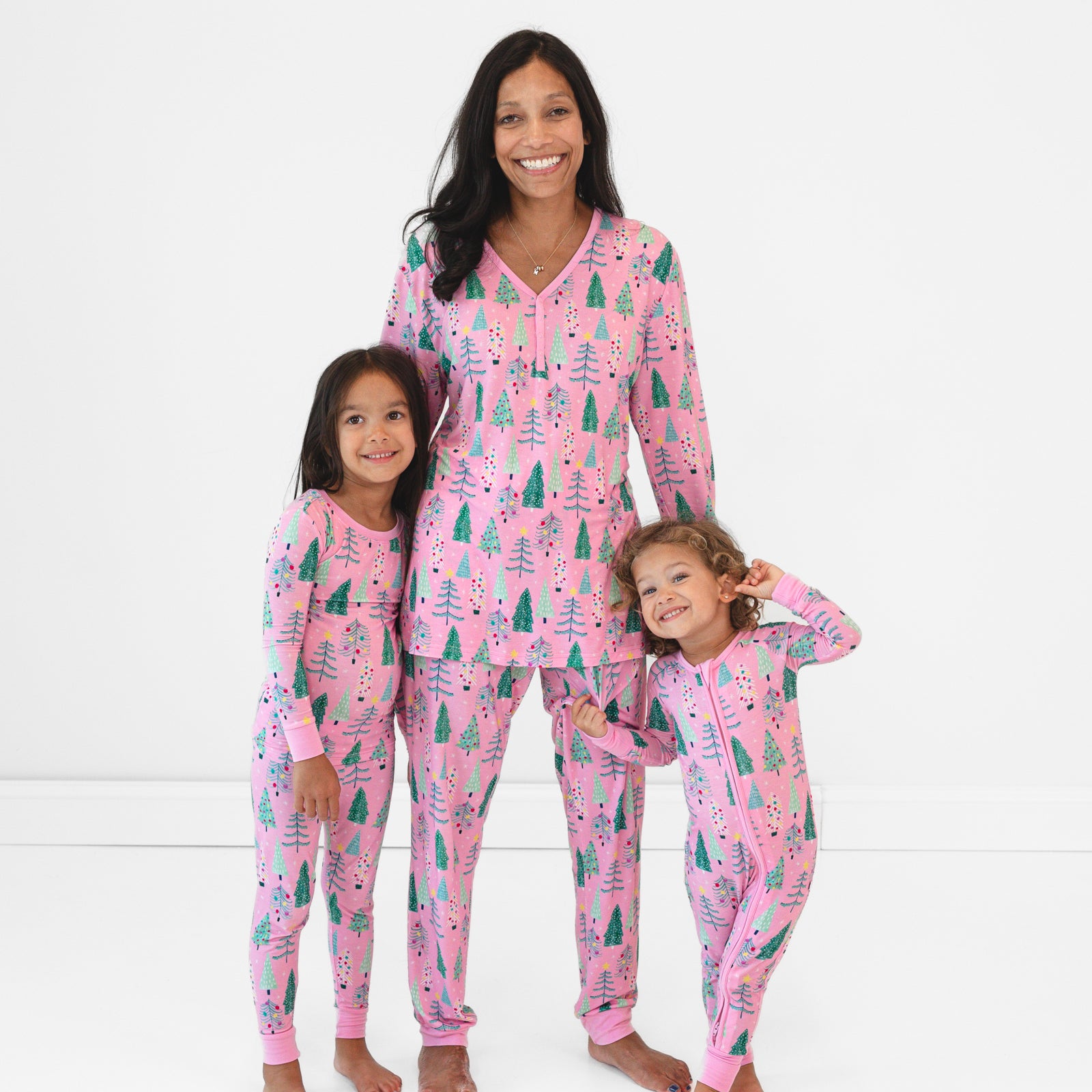 Image of a mother and two children wearing matching Pink Twinkling Trees pajamas