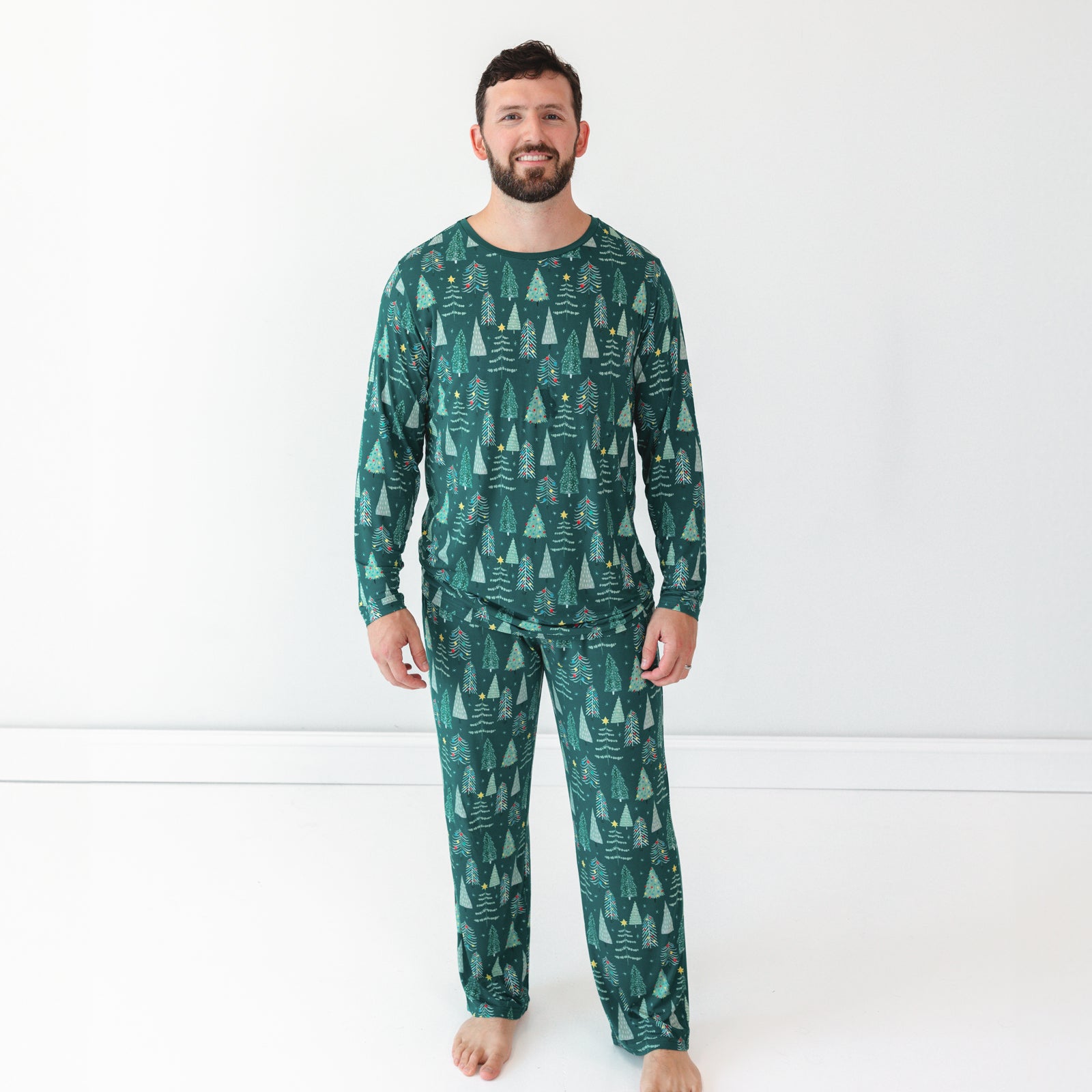 Male model wearing the Green Twinkling Trees Men's Pajama Pants and Top