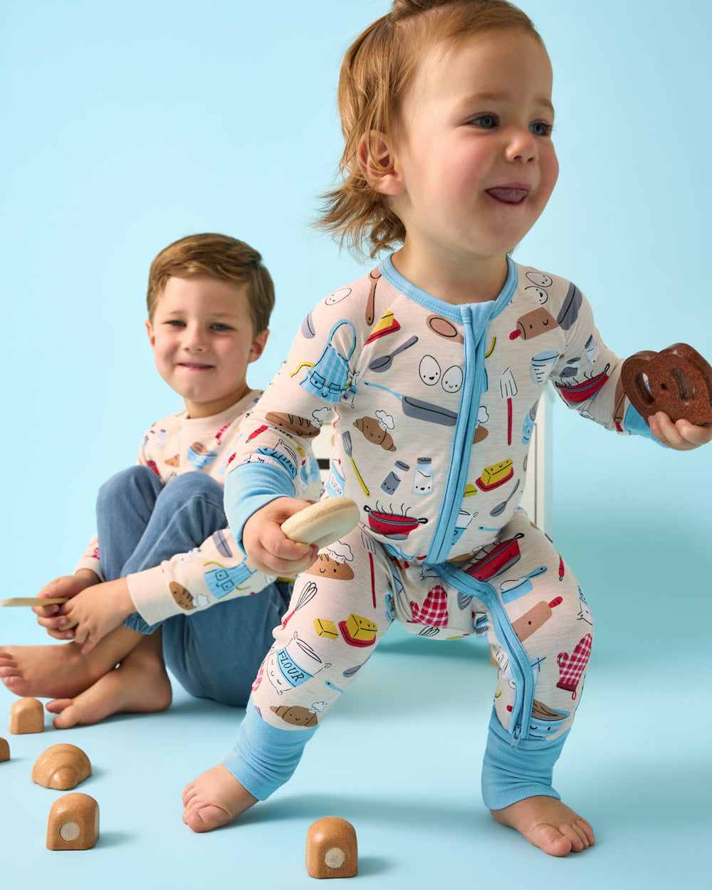 Child wearing the Little Chef Zippy playing with food themed toys