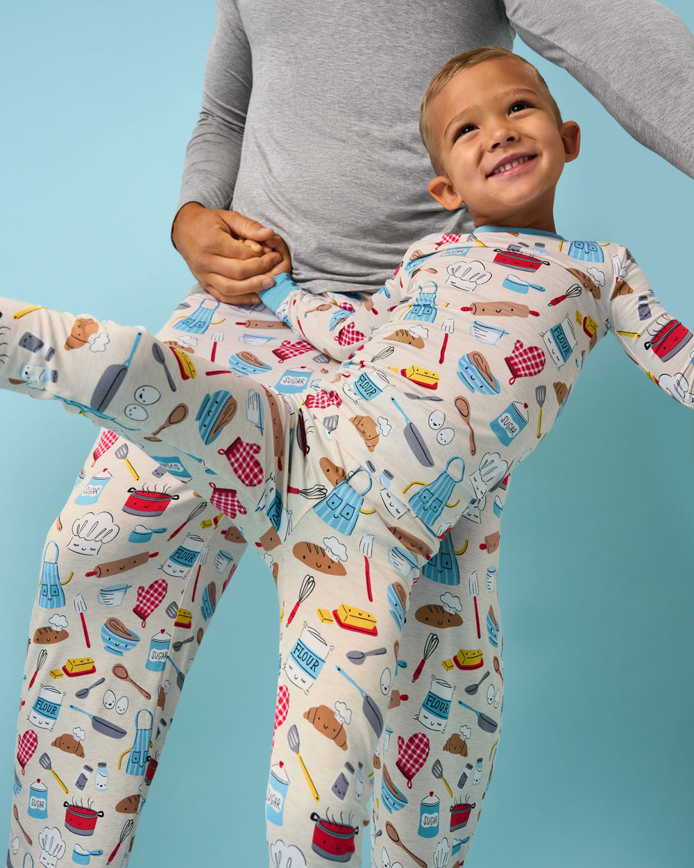 Child wearing the Little Chef Two-Piece Pajama Set on a blue background