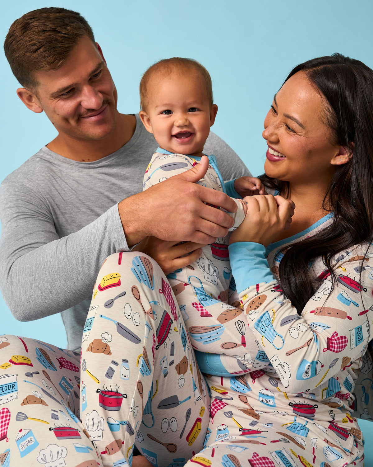 Family of three wearing matching Little Chef pajamas