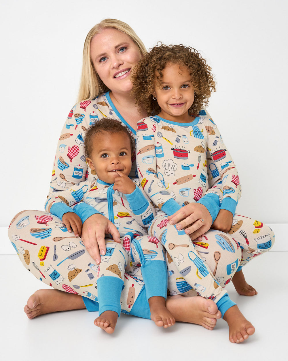 Mother and two children wearing matching Little Chef pajamas