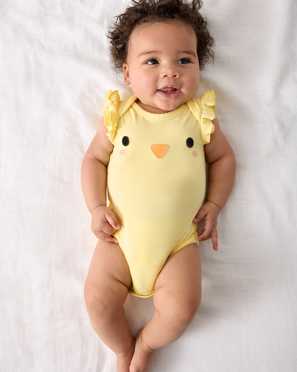 Aerial view of baby wearing the Little Chickie Flutter Bodysuit