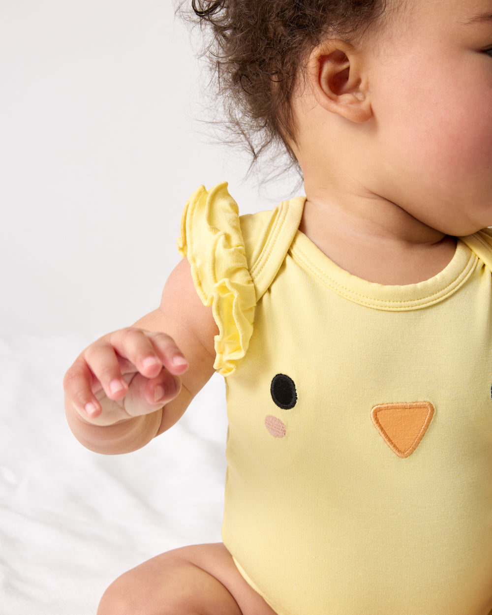 Close up of the shoulder detail on the Little Chickie Flutter Bodysuit