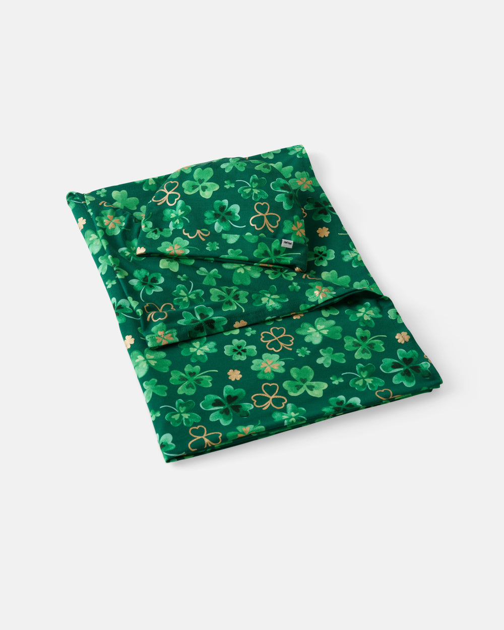 Flat lay of the Clover Cuties Swaddle & Hat Set