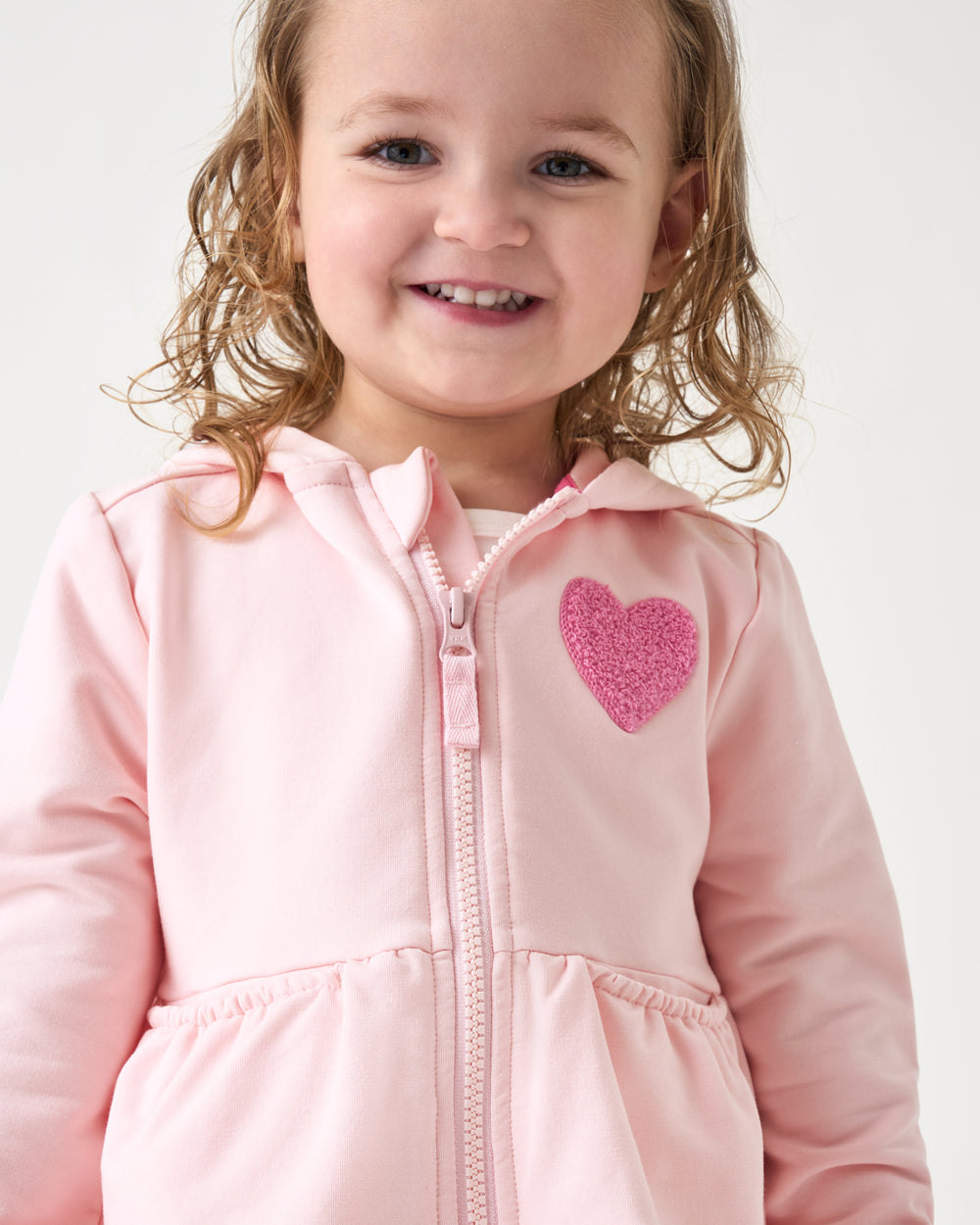 Close up of girl wearing the Little Love Flare Zip Hoodie