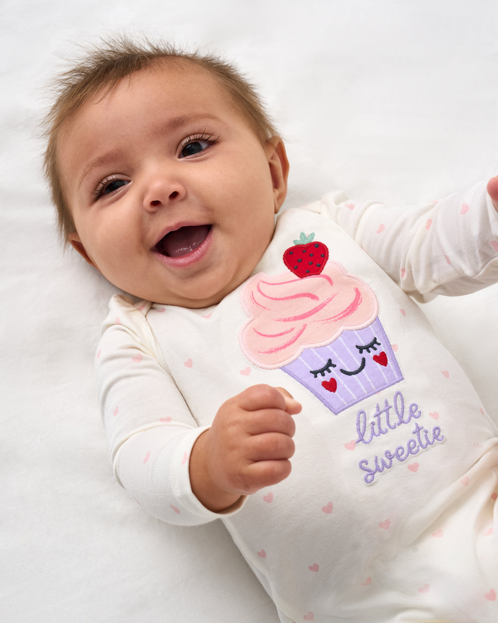 Close up of baby wearing the Little Sweetie Puff Sleeve Bodysuit