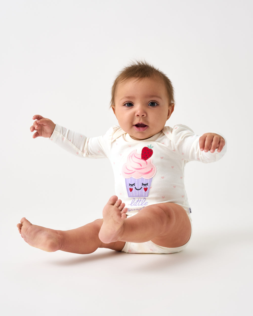 Alternate sitting baby wearing the Little Sweetie Puff Sleeve Bodysuit