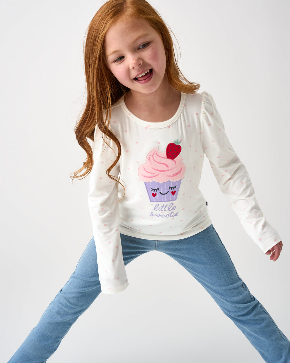 Girl wearing the Little Sweetie Puff Sleeve Tee with denim pants