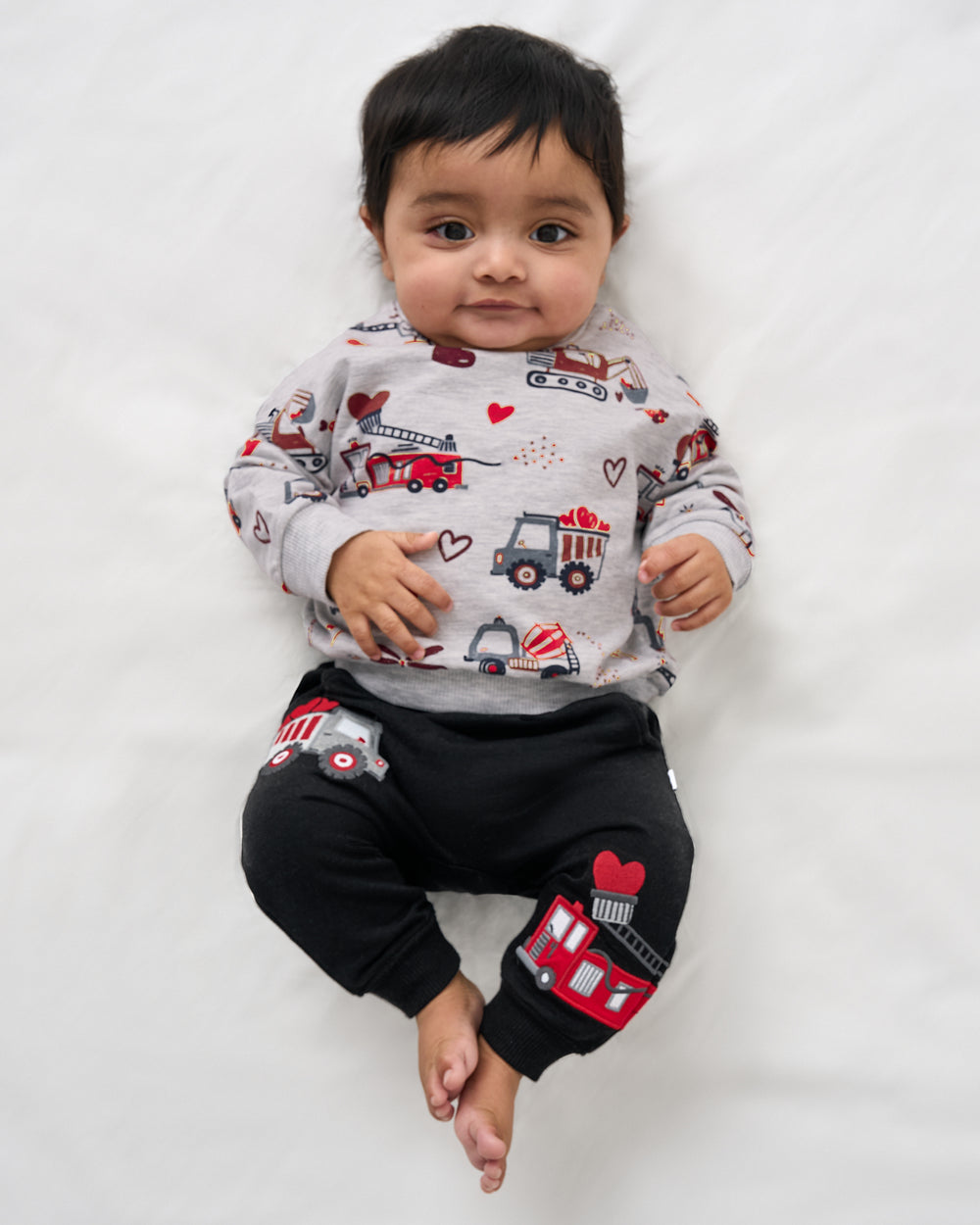 Aerial view of baby wearing the Loads of Love Easy Crewneck Sweatshirt and Sweatpants