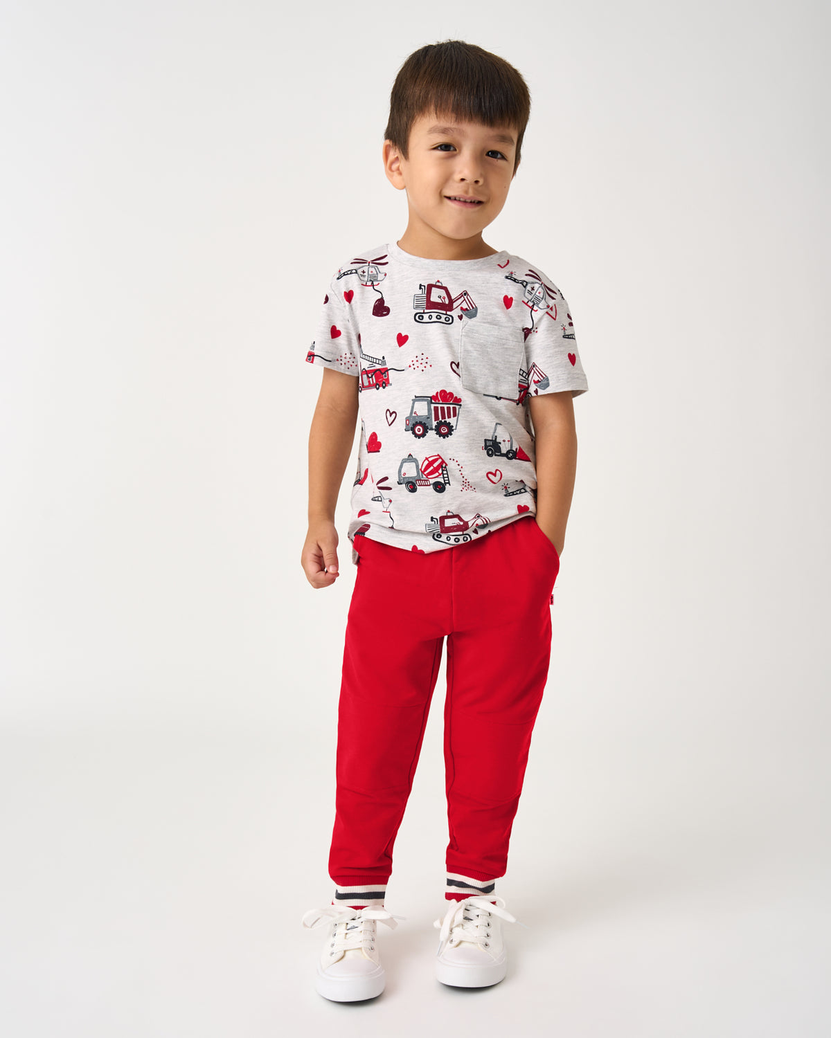 Boy wearing the Loads of Love Relaxed Pocket Tee with red joggers