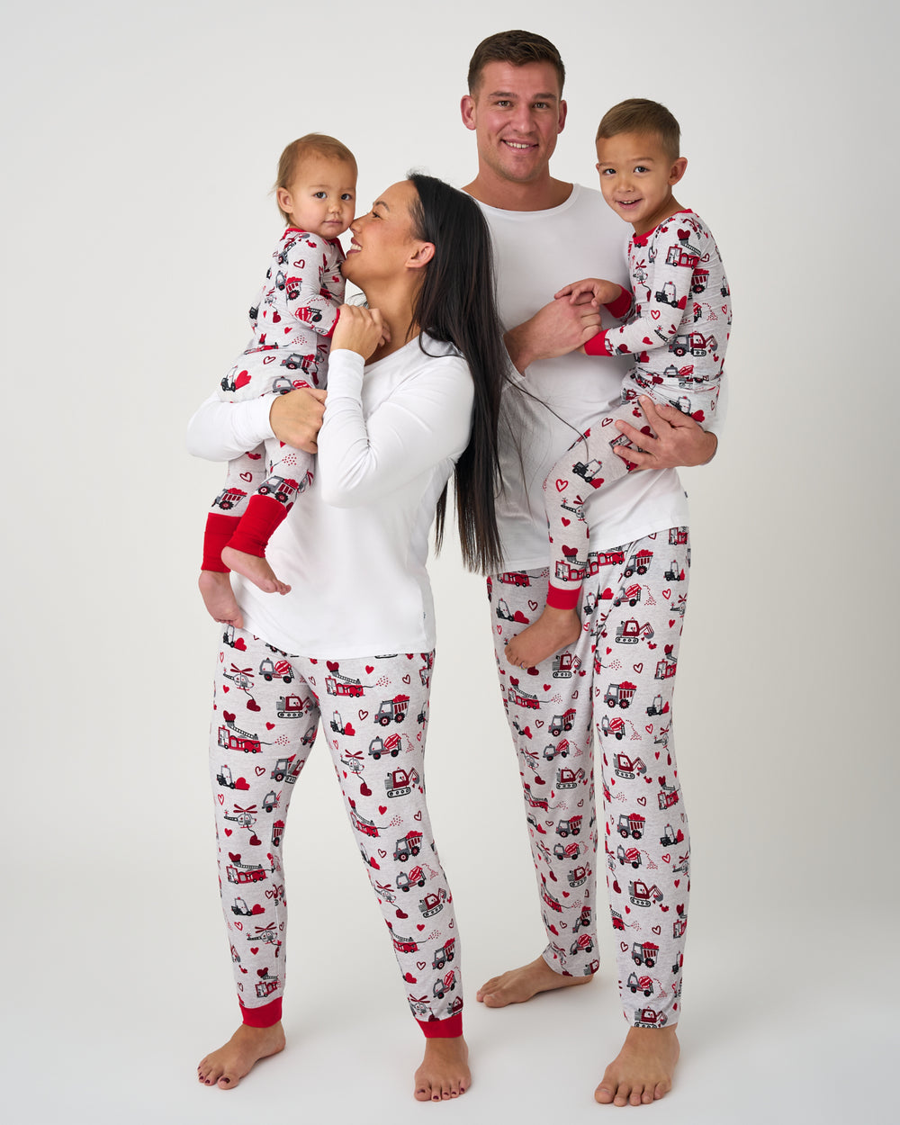Family of four wearing Loads of Love matching Valentines Day Pajamas