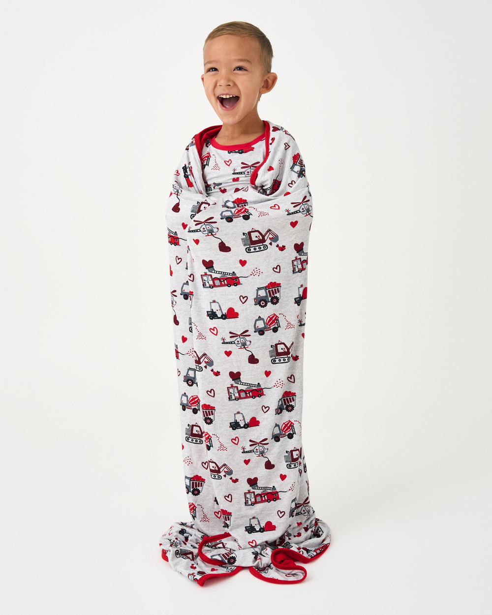 Standing boy wrapped in the Loads of Love Large Cloud Blanket®