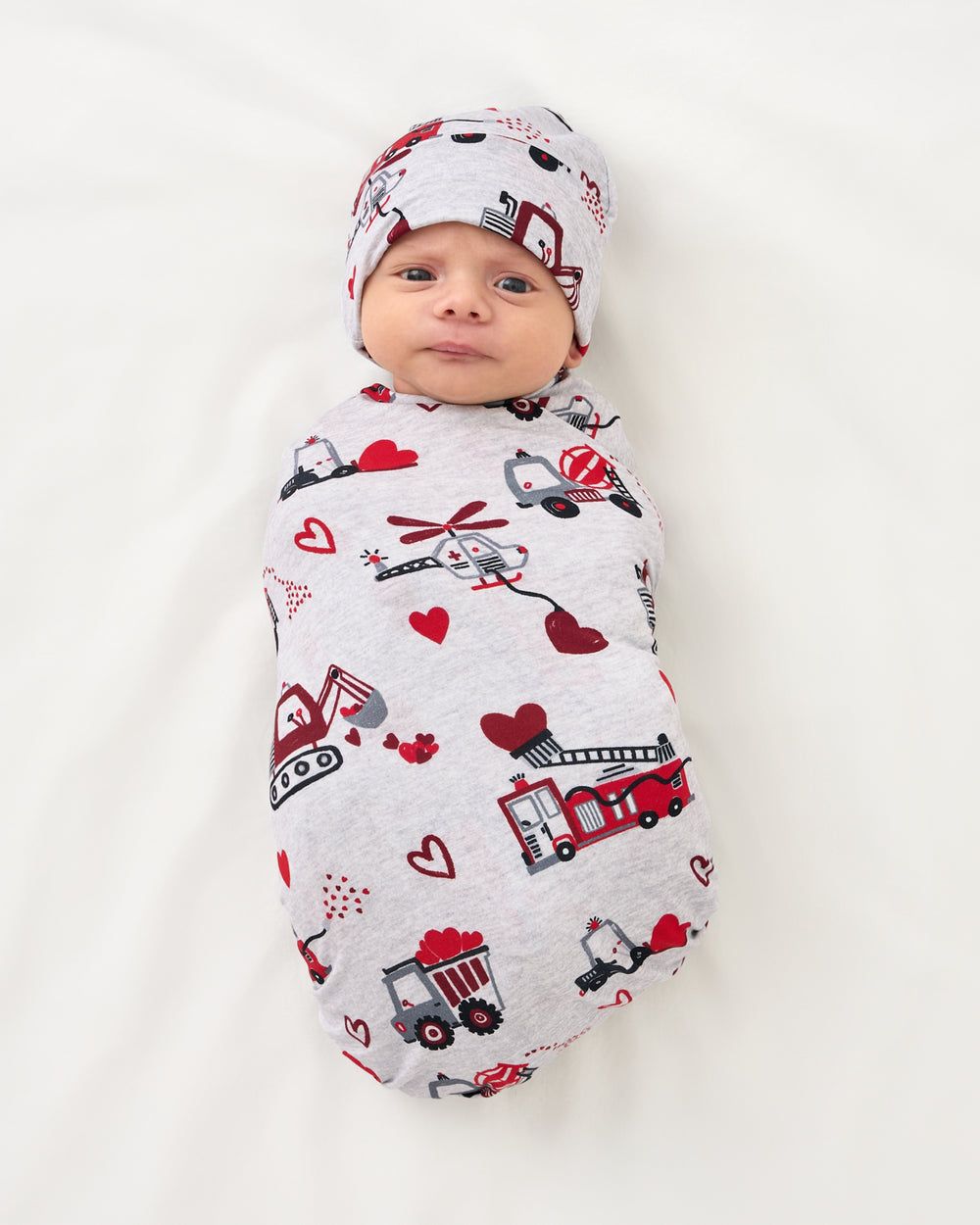 Aerial view of baby swaddled in the Loads of Love Swaddle & Hat Set