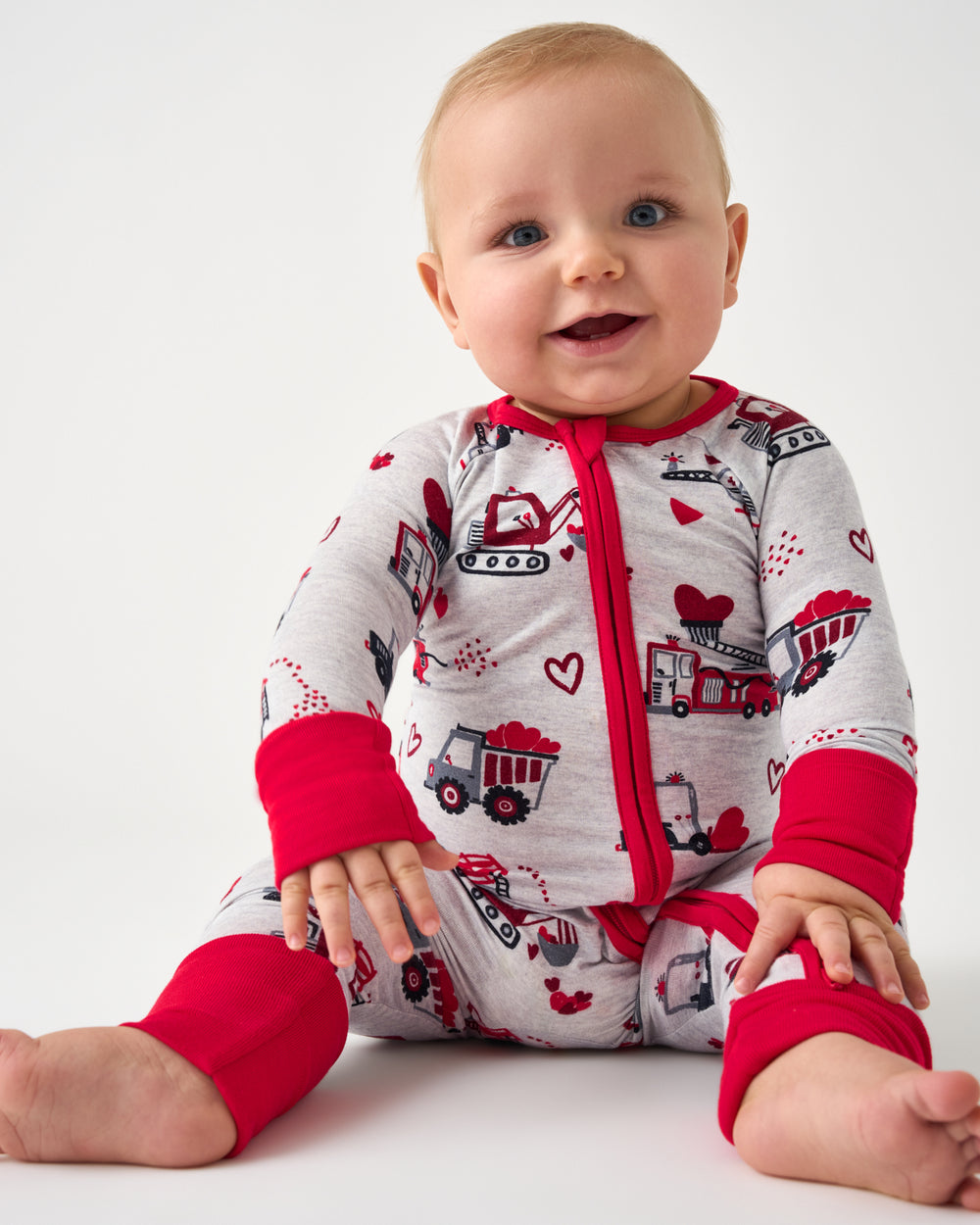 Sitting baby wearing the Loads of Love Zippy