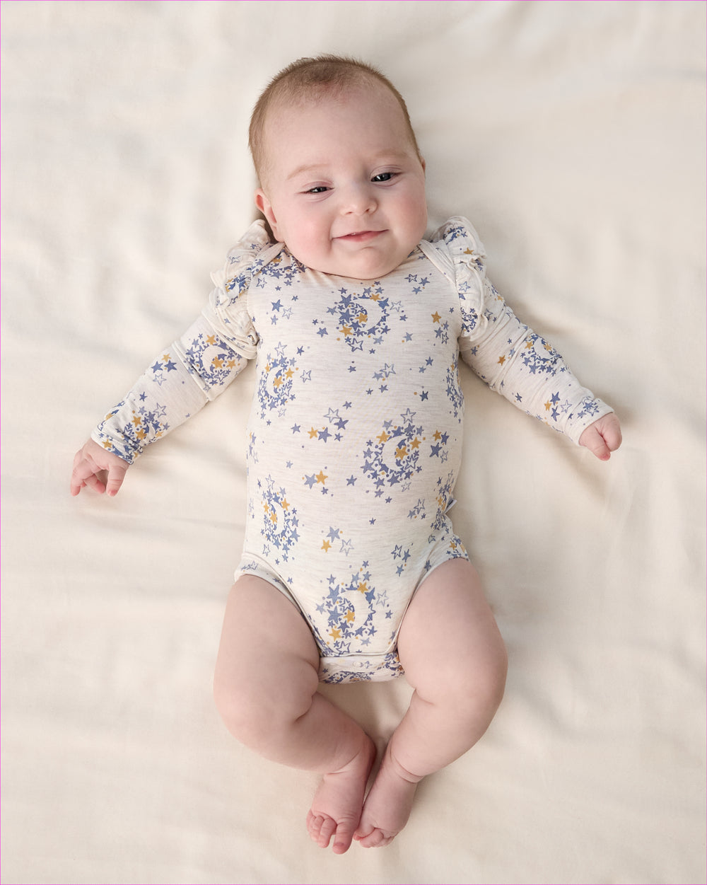Aerial view of baby wearing the Lullaby Sky Flutter Bodysuit