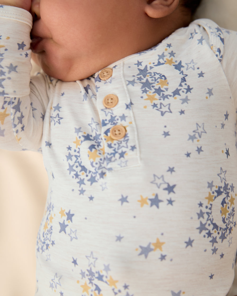 Close up of the henley button detail on the Lullaby Sky Henley Bodysuit