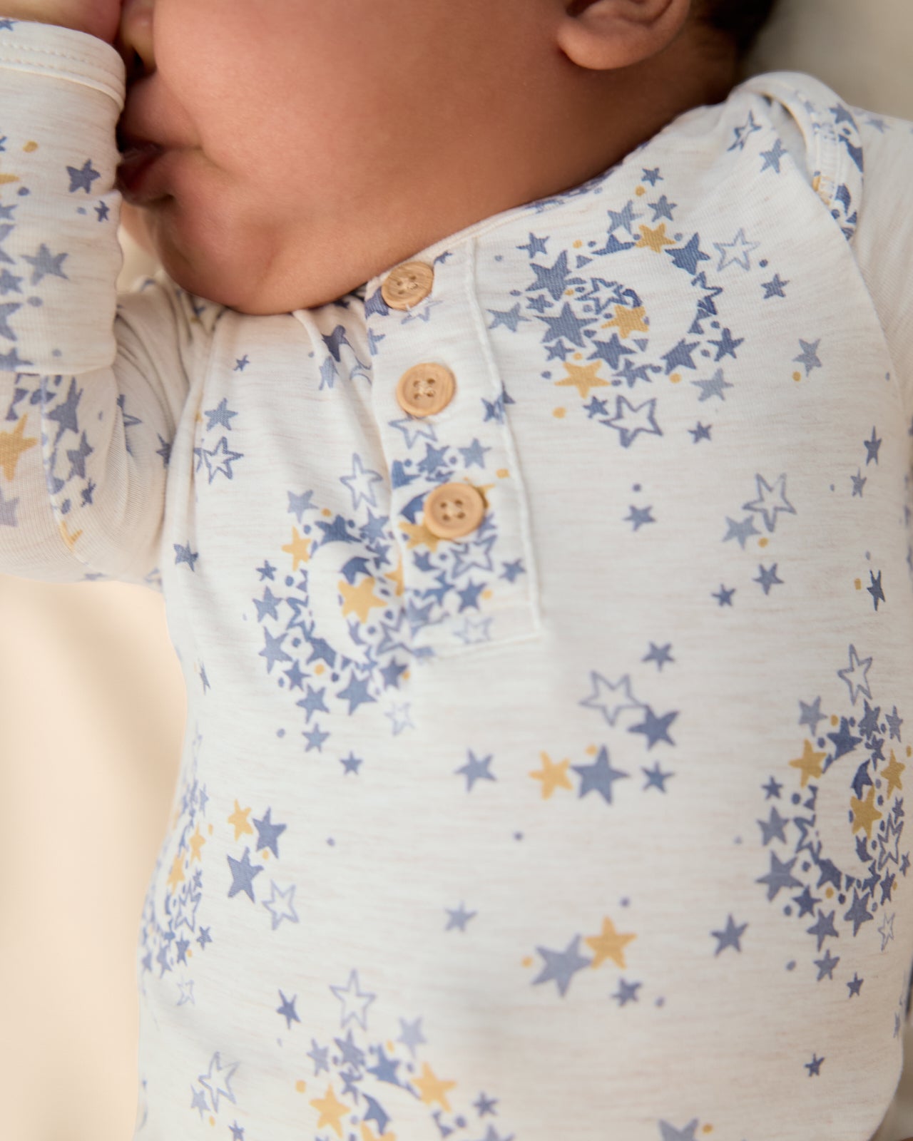 Close up of the henley button detail on the Lullaby Sky Henley Bodysuit