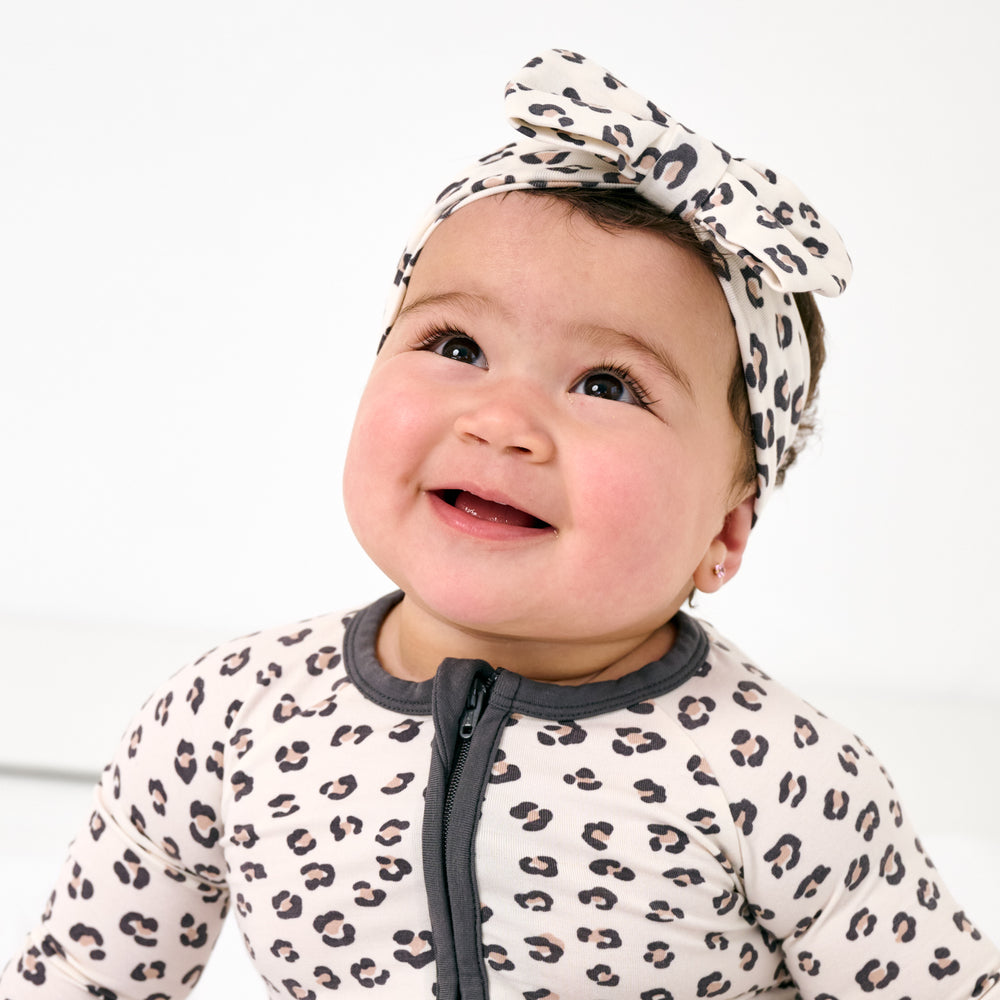 Close up of baby wearing the Luxe Leopard Luxe Bow Headband