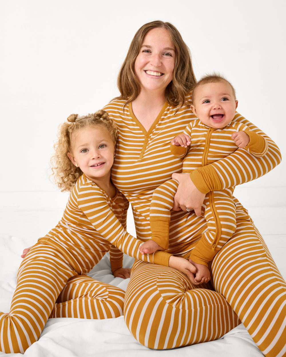 Mother and two children wearing Marigold Stripe bamboo pajamas