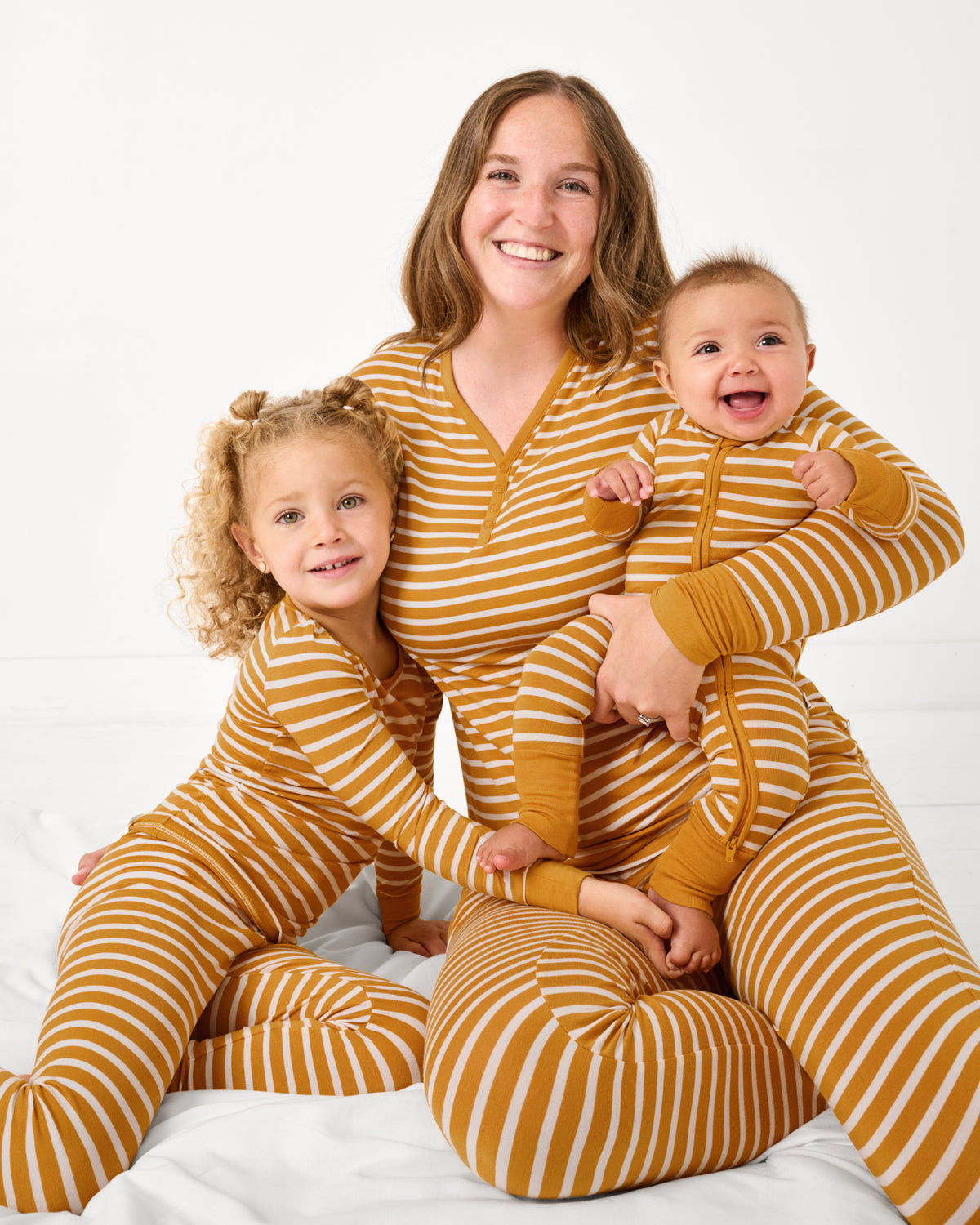 Mother and two children wearing Marigold Stripe bamboo pajamas
