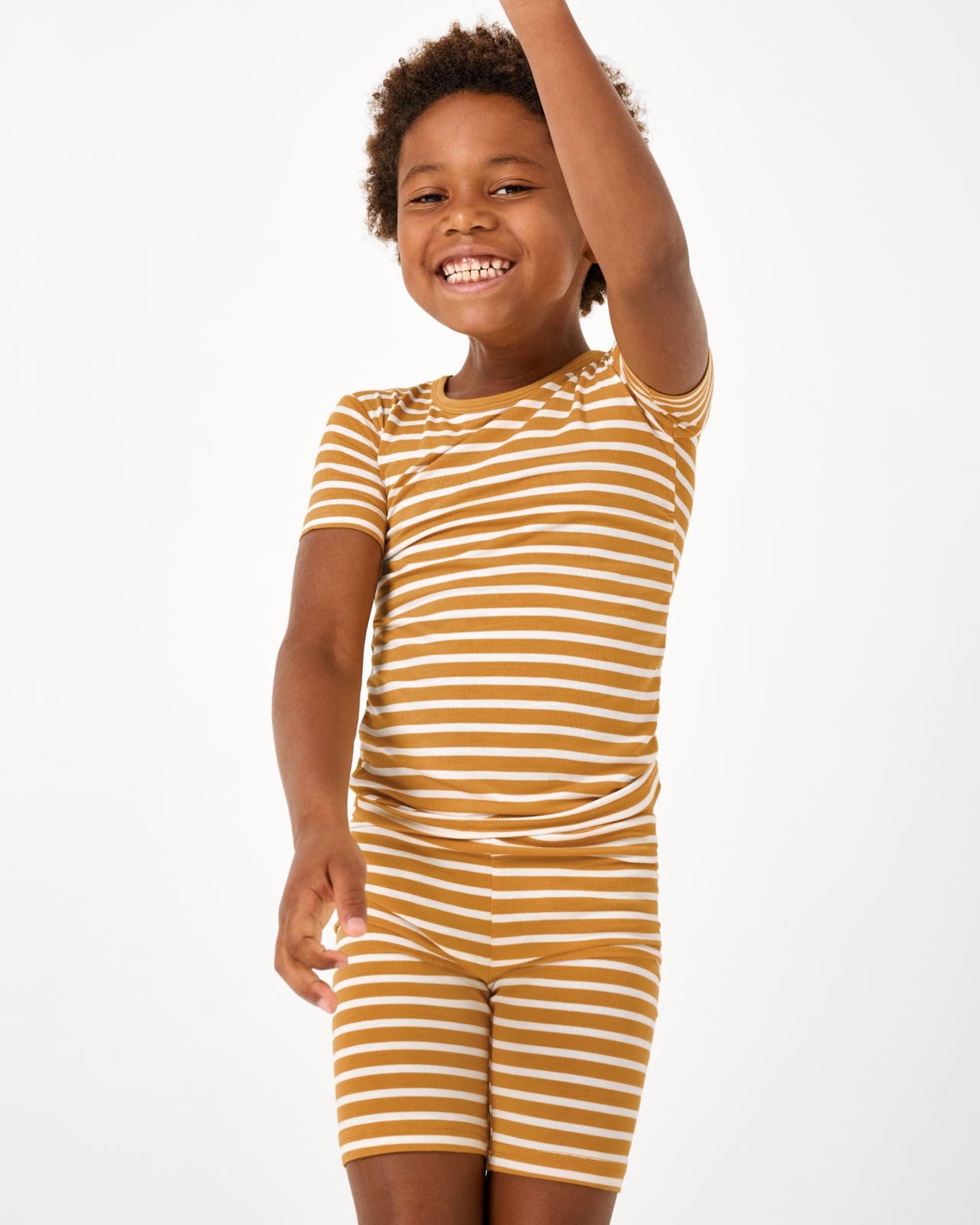 Close up of boy wearing the Marigold Stripe Two-Piece Short Sleeve & Shorts Pajama Set