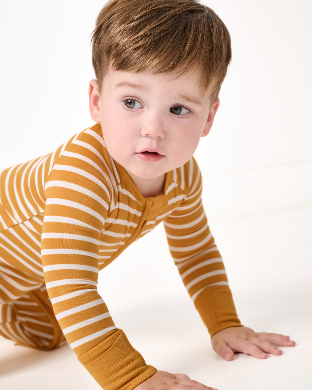 Crawling child wearing the Marigold Stripe Zippy