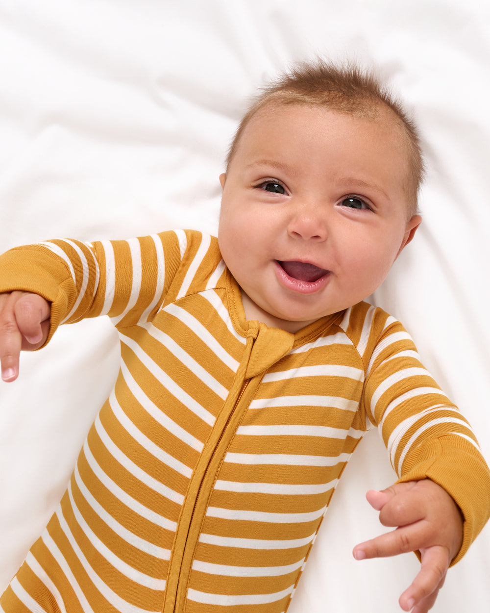 Close up of baby wearing the Marigold Stripe Zippy