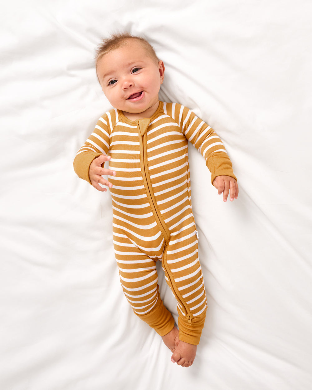 Aerial view of baby wearing the Marigold Stripe Zippy