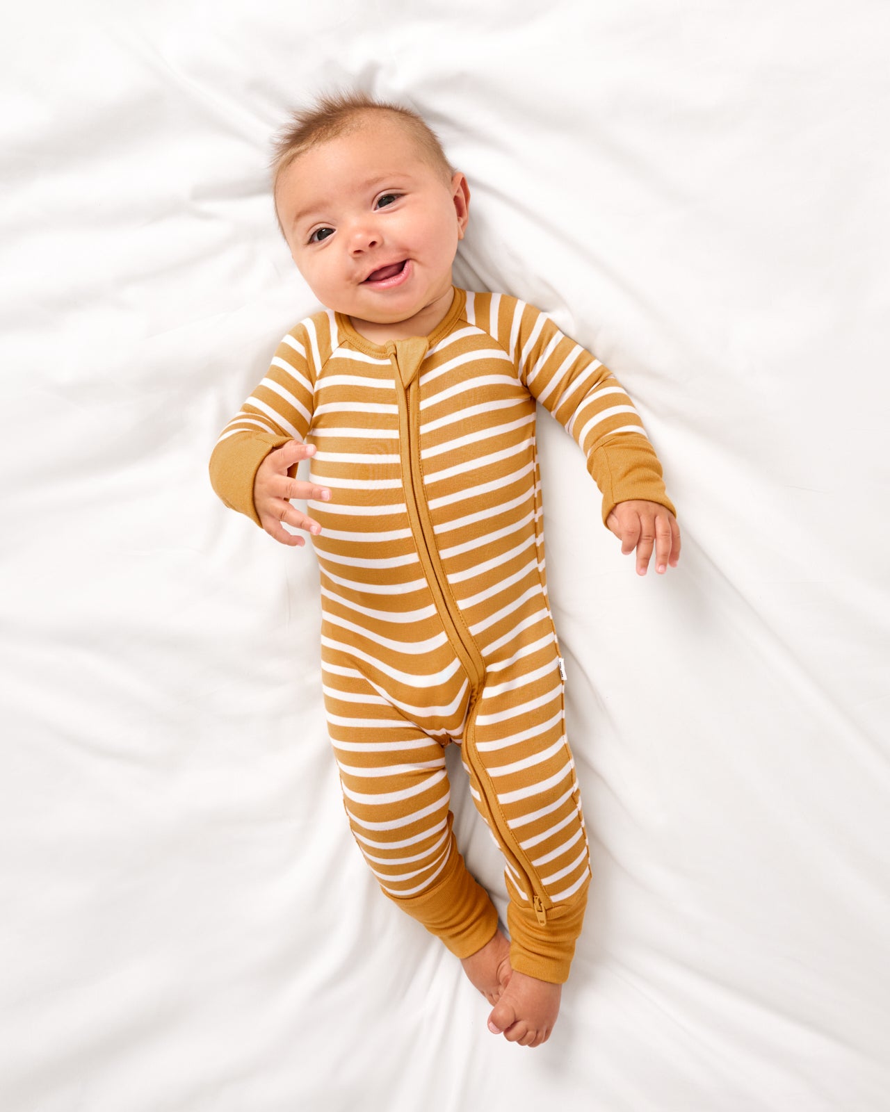 Aerial view of baby wearing the Marigold Stripe Zippy
