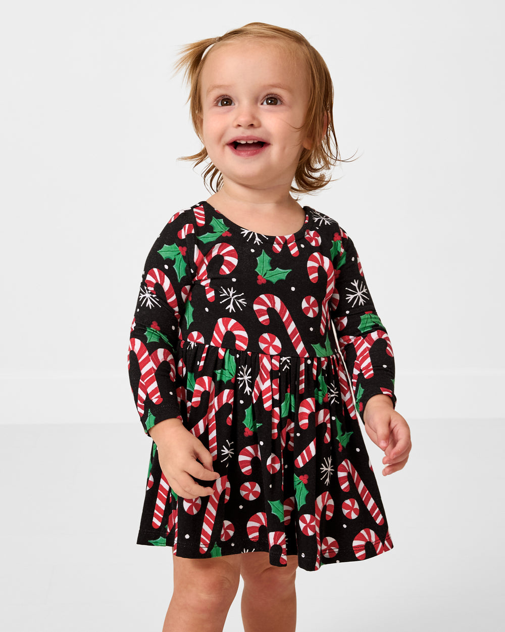 Toddler wearing the Merry Mints Bow Back Skater Dress with Bodysuit