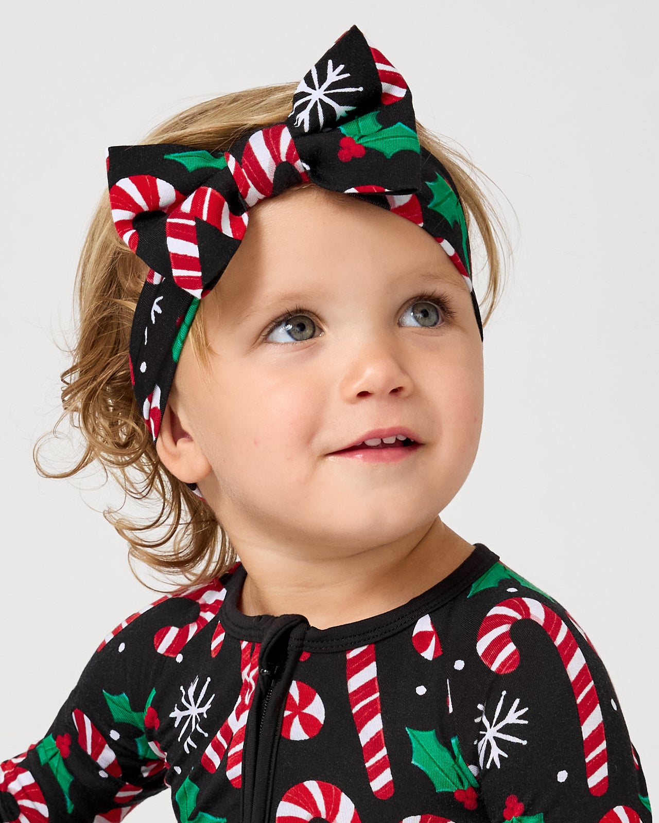 Close up of toddler wearing the Merry Mints Luxe Bow Headband
