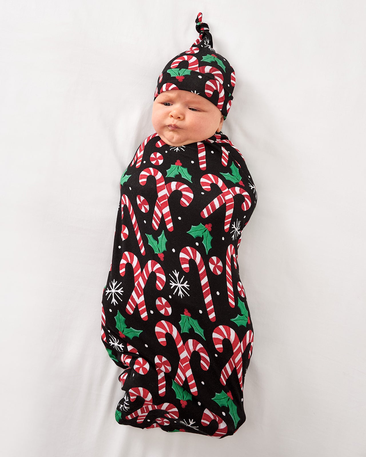 Aerial view of baby in the Merry Mints Swaddle & Hat Set