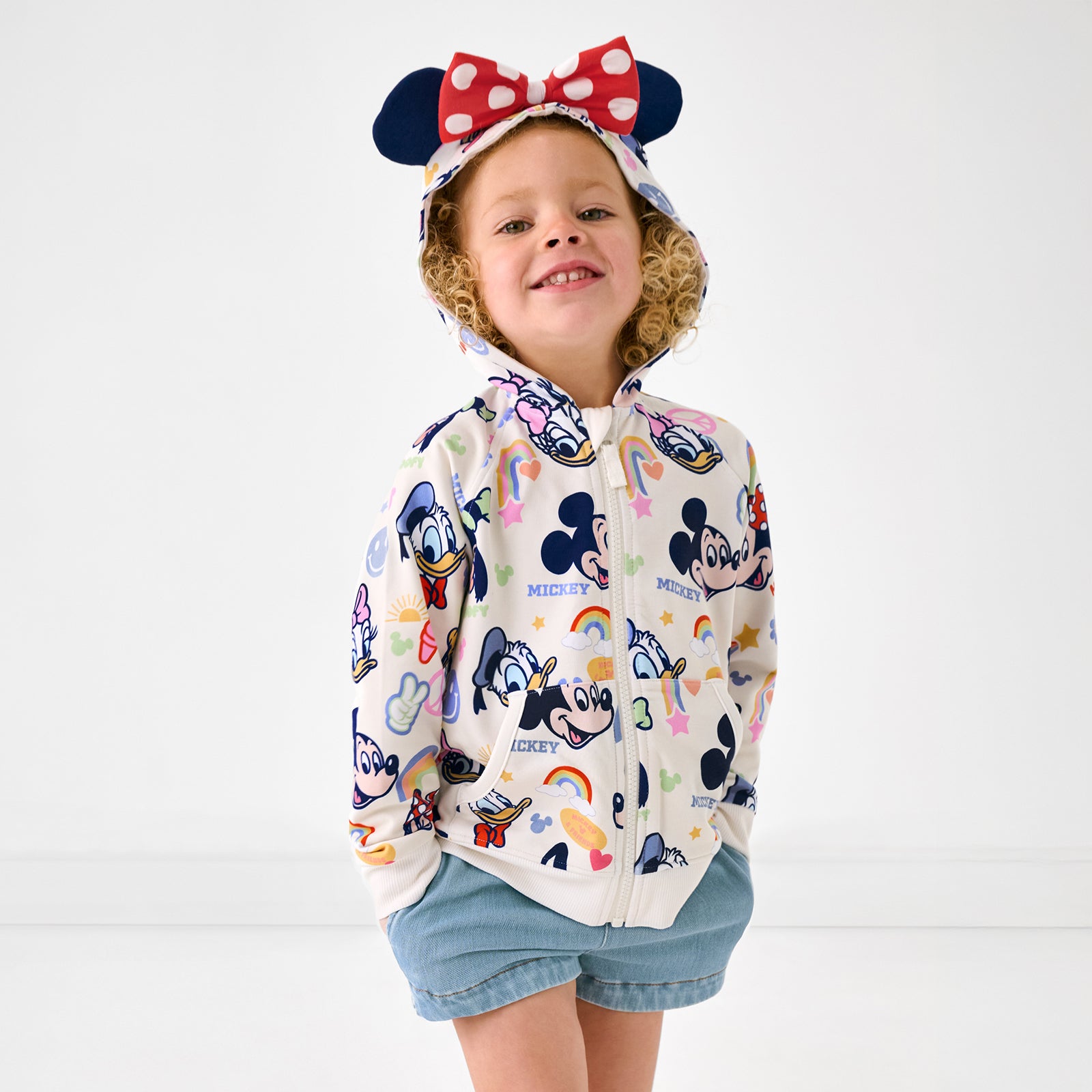 Standing girl wearing the Disney Mickey's Clubhouse Minnie Zip Hoodie