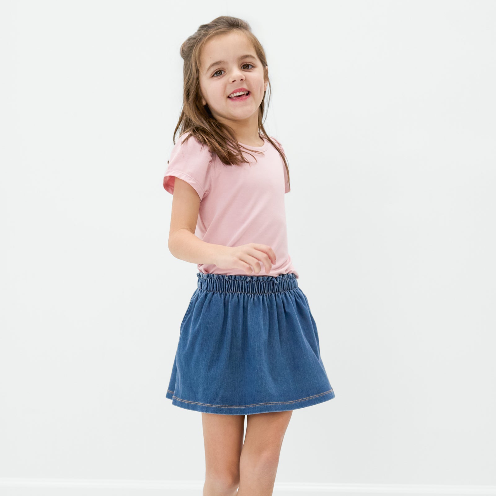 Standing child wearing the Midwash Denim Skort 