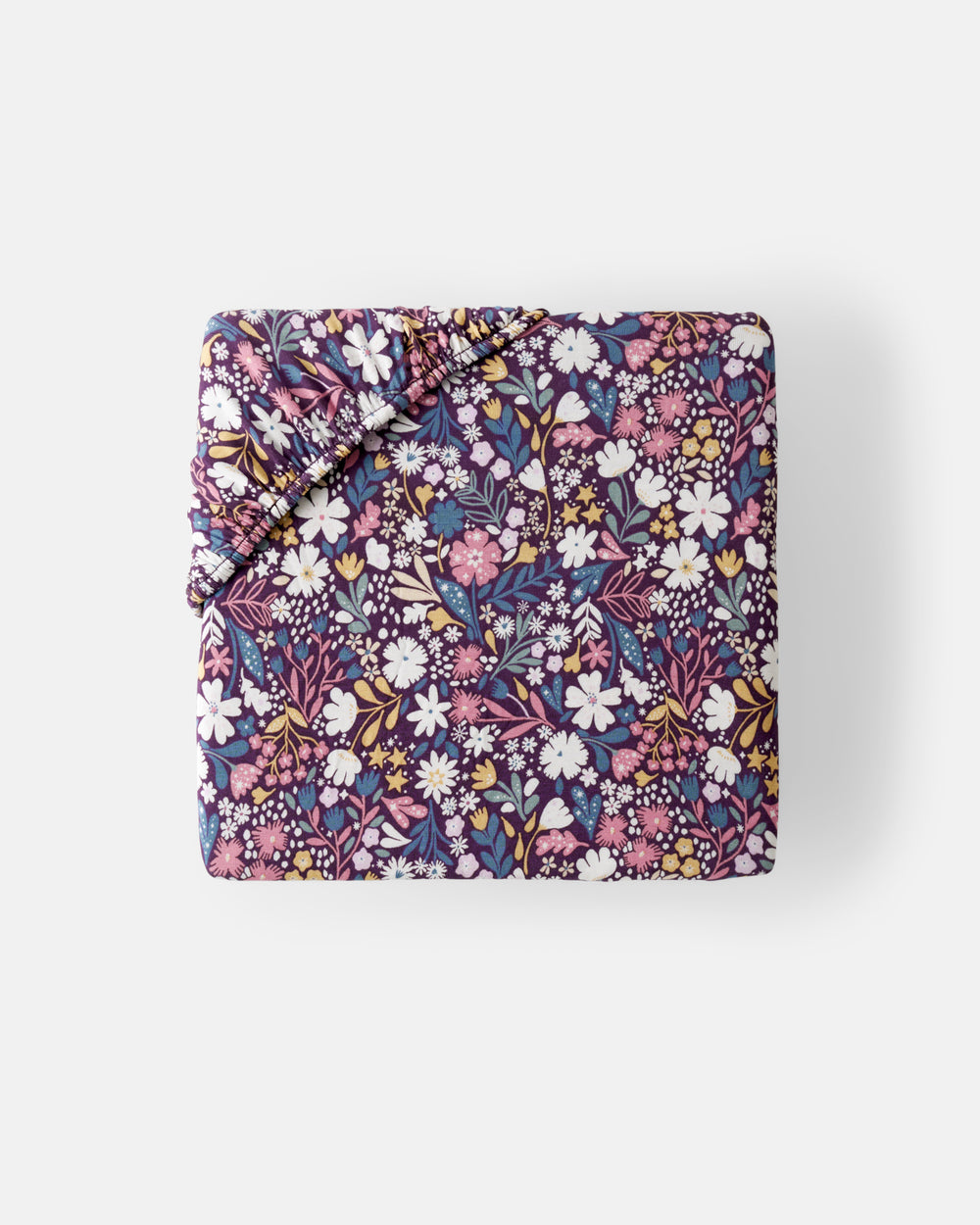 Flat lay of the mini Midnight Petals Fitted Crib Sheet