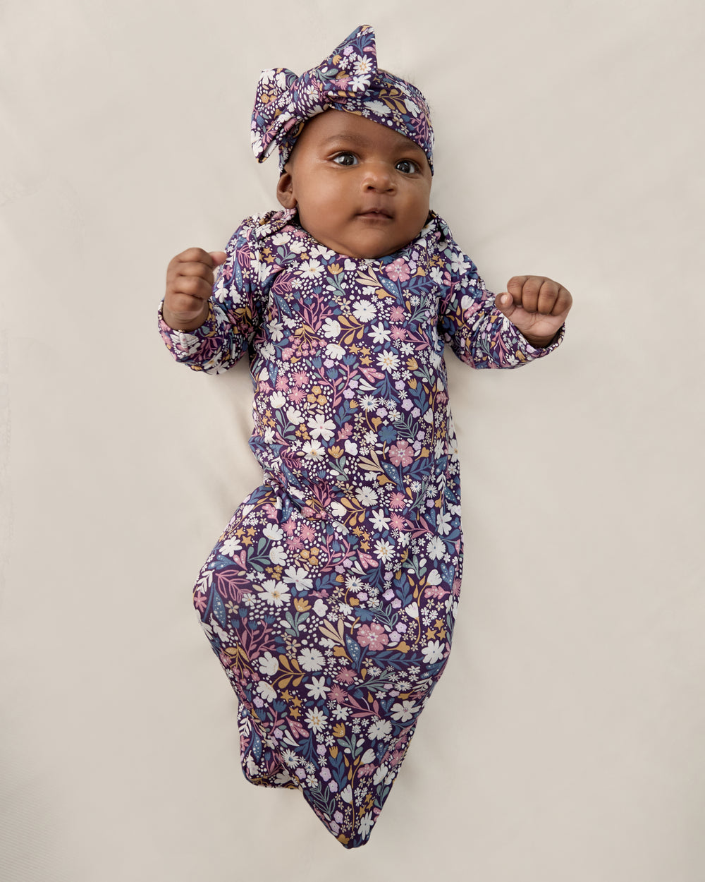 Baby wearing the Midnight Petals Infant Gown and Luxe Bow Headband