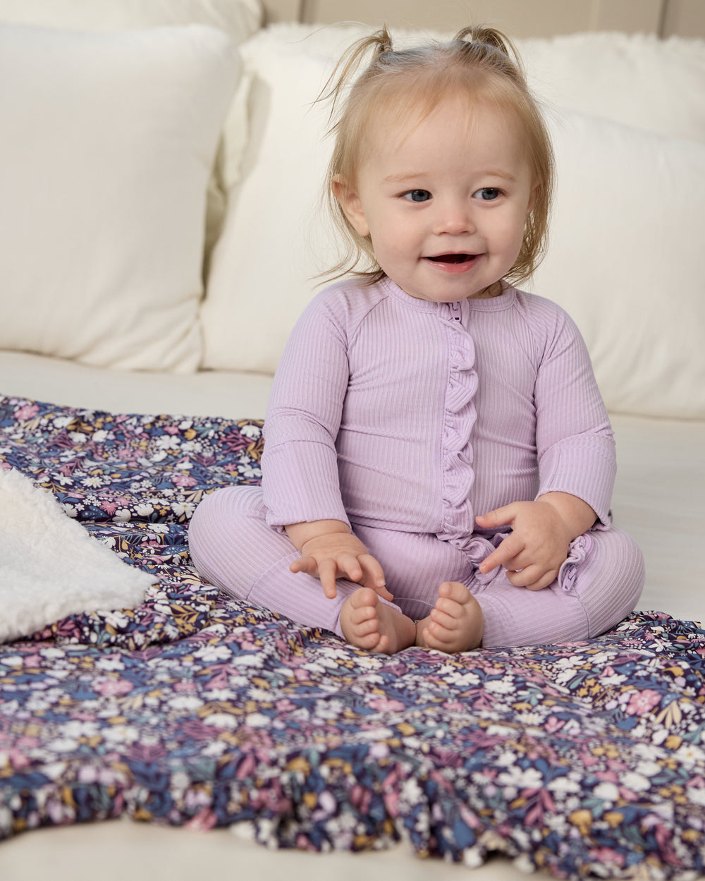 Baby sitting on the Midnight Petals Ruffle Mini Cloud Blanket®