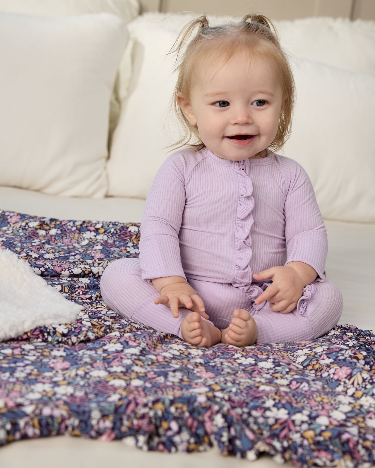 Baby sitting on the Midnight Petals Ruffle Mini Cloud Blanket®