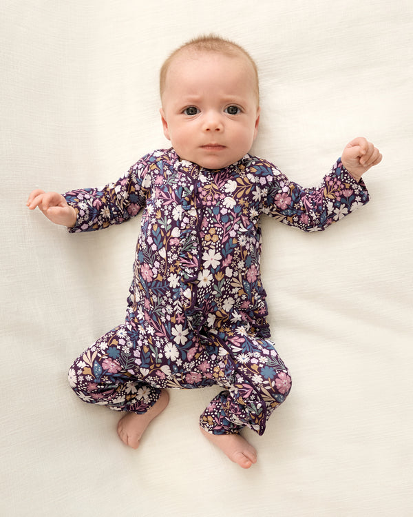 Newborn wearing the Midnight Petals Ruffle Zippy