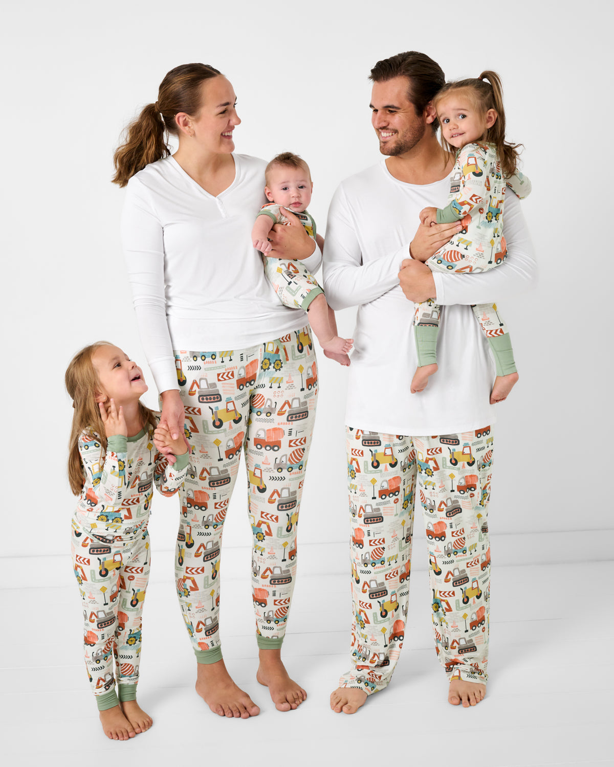 Family of five wearing matching construction themed pajamas